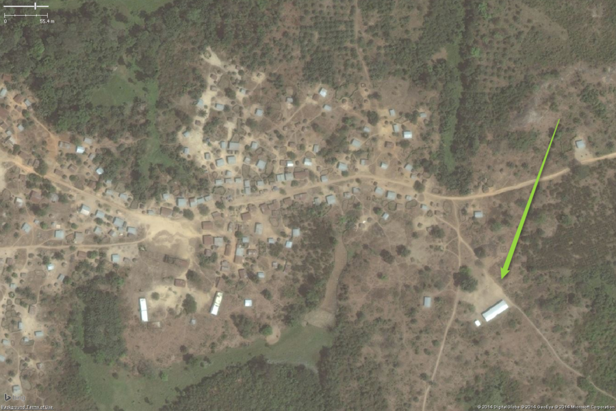A typical rural school in West Africa. This zoomed out view shows a likely school on the eastern edge of the village. Please note the two long buildings on the western side of the image could easily be confused for school areas, but the lack of a large clear yard and toilet buildings suggests they are not schools. The overall school property should be tagged with amenity=school.