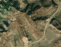 4/8 Untidy cemetery (landuse=cemetery), without structure on hilly terrain (Maxar satellite imagery).