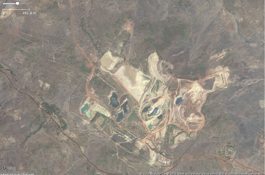 A typical site of surface mining in west africa. This zoomed in view shows the key features: pools of ground,funny color,exposed ground.The overall area should be tagged with landuse=quarry.