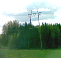 A bit smaller power tower with wooden vertical parts. High voltage, as seen from the insulators.