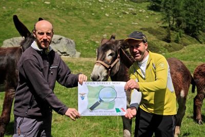 Two people (and some donkeys) at the "Dal gps alla montagna" Mapping Party, an event in the mountains of Trentino, Italy.