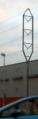 A narrower-than-usual tower carrying a 110 kV line - tower fits on a highway median.