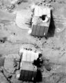 Aerial view of bomb-damaged concrete hangars at the Ahmed Al Jaber Airfield in Iraq.