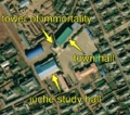 1/7 City centre that concentrates an immortality tower (historic=memorial and memorial=immortality_tower), with its shadow cast on the ground, a juche study hall (amenity=community_centre), with its specific shape, and a city hall (amenity=townhall) (Maxar satellite imaging).