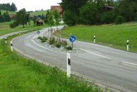 A traffic-calming island between the lanes of a 2-lane road.