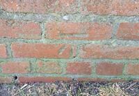A line cut into the side of a brick wall