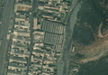 5/7 Public market (amenity=marketplace) with many stalls, surrounded by a perimeter wall (Maxar satellite imagery).