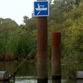 Waterway sign CEVNI E.19: "Craft other than motorized vessels or sailing craft permitted" on a canoeing route in Biesbosch, the Netherlands (placed on a construction that limits width of passing craft to approximately 1 meter)