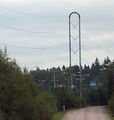 A high voltage line tower with a staple shape structure.
