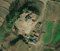 2/6 Farmyard (landuse=farmyard) surrounded by a fence with hay stacks, connected to the road (Maxar satellite imagery).