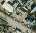 2/3 The same gas station (amenity=fuel), close to a road, in an urban area with quick access to the road. On this satellite imagery, the flat roof structure and the four pillars can be seen thanks to the shadow on the ground (Esri satellite imagery).