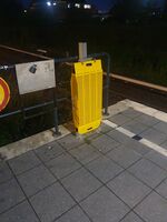 A portable ramp at a railway platform at night.