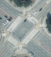 A junction at right angles with a circular island in the center.