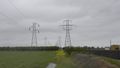 Steel lattice power towers carrying single-circuit and dual-circuit 115 kV / 60 Hz power lines.