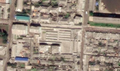 4/7 Public market (amenity=marketplace) with nine stalls, surrounded by a perimeter wall along an axis running through them (Maxar satellite imagery).