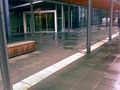 tactile_paving=incorrect - The paving is not where you walk - You run into the poles. The paving to the door is missing / there are tactile elements used for decoration.
