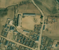 3/4 Rarer form of school (amenity=school) consisting of two long buildings close together at right angles (building=school) with a large courtyard in front (Maxar satellite imagery).
