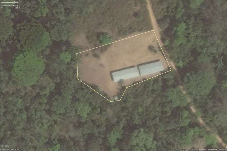A typical rural school in West Africa. This zoomed in view shows the key features: 1 or 2 long buildings, 1 or 2 smaller toilet buildings, a large bare field. The overall school property should be tagged with amenity=school and the buildings with building=yes.