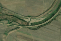 1/6 Dam (waterway=dam) that comes to cut off from a stream by its thick structure (Maxar satellite imagery).