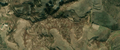 7/8 Disorganised cemetery (landuse=cemetery), without structure on hilly terrain (Maxar satellite imagery).