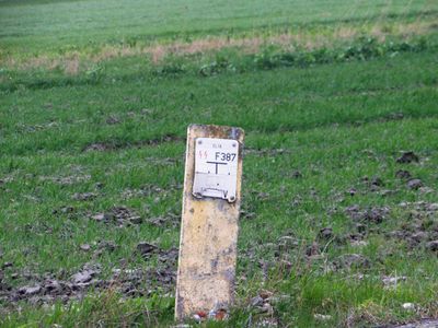 A yellow pedestal with a broken sign